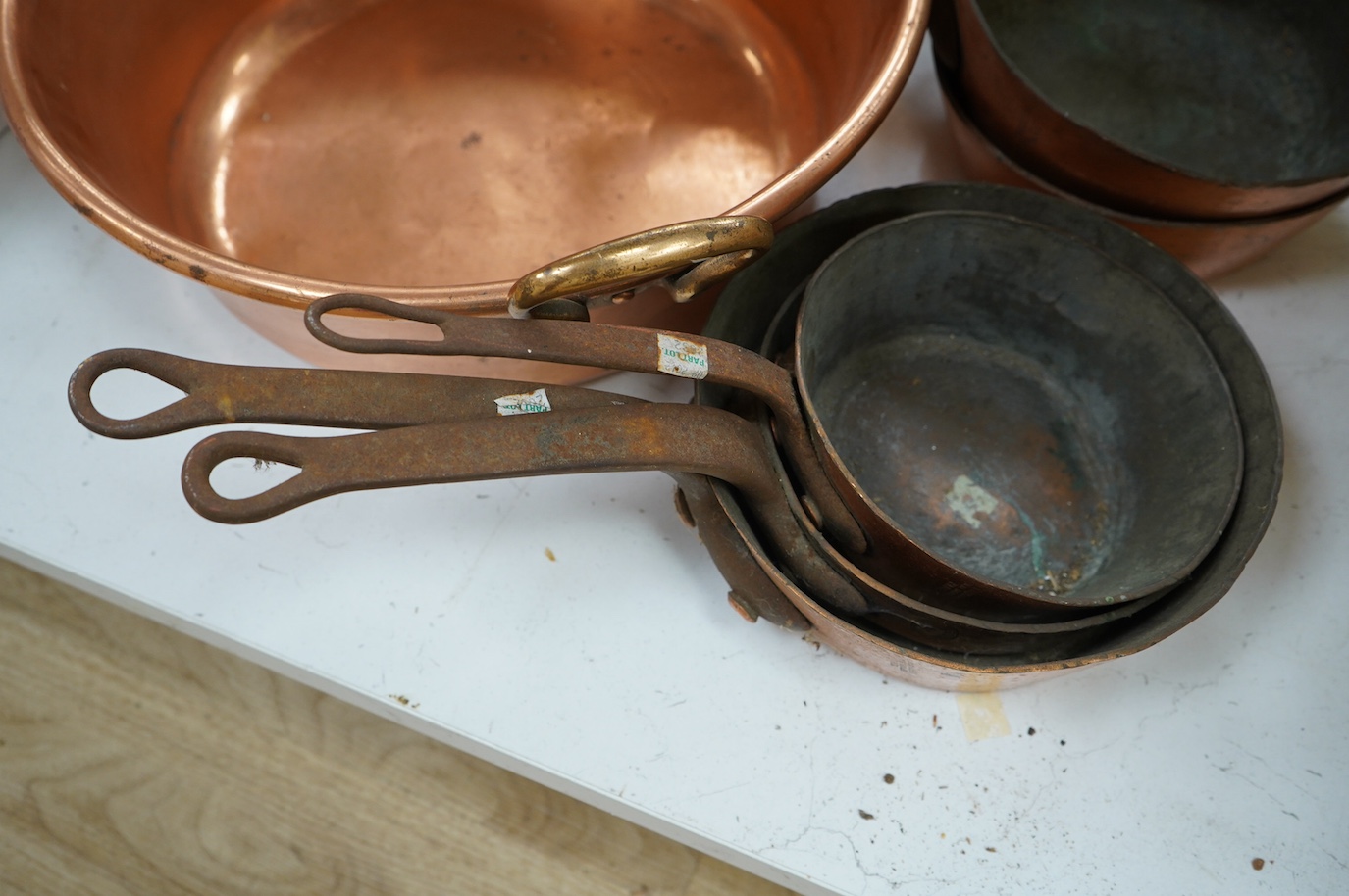 A set of five graduated copper cooking pans by E. Dehillerin of Paris, together with a copper preserve pan, 45cm. Condition - poor to fair